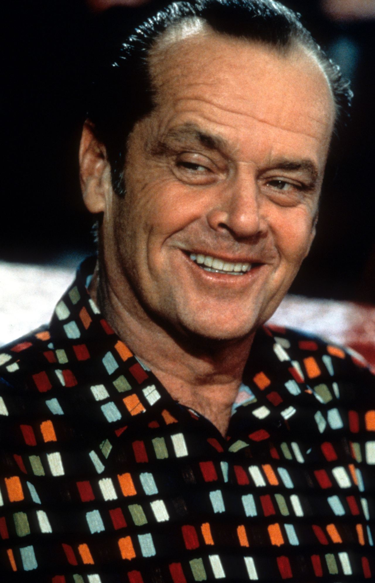 Nicholson, who turned 60 in 1997, projected a completely different energy as he grinned mischievously in a scene from "As Good as It Gets." With his slicked-back hair, patterned shirt, and unmistakable smirk, he embodied a more classic, grounded kind of charisma — less polished, more unpredictable, and entirely his own.