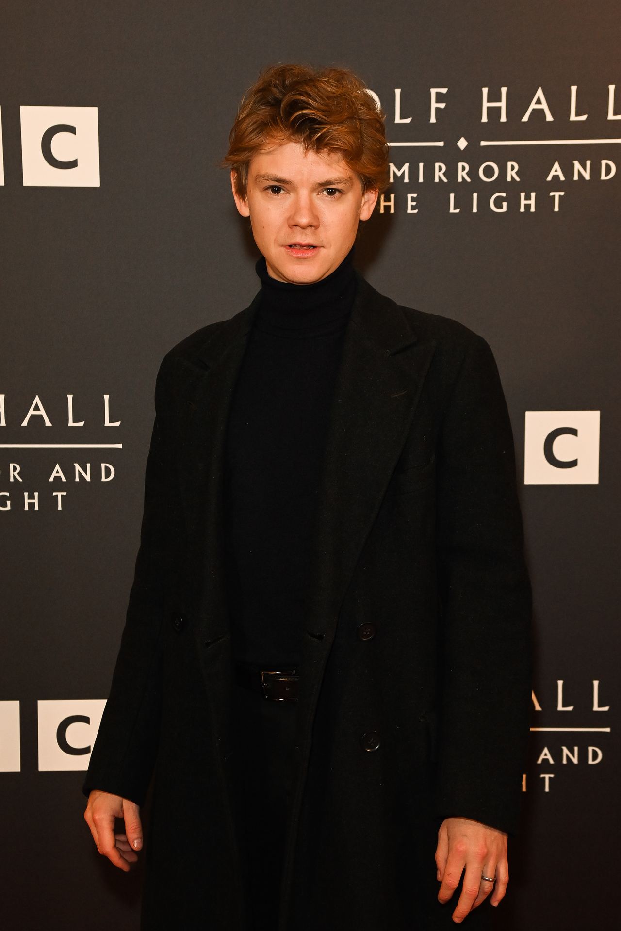 Brodie-Sangster, 34 in 2024, appeared at a London photocall for "Wolf Hall: The Mirror and the Light" with his signature slender frame, tousled hair, and boyish features still firmly intact. Dressed in an all-black ensemble with a modern cut, he carried himself with a quiet intensity that leaned more cerebral than rugged — a presence that felt both refined and reserved.