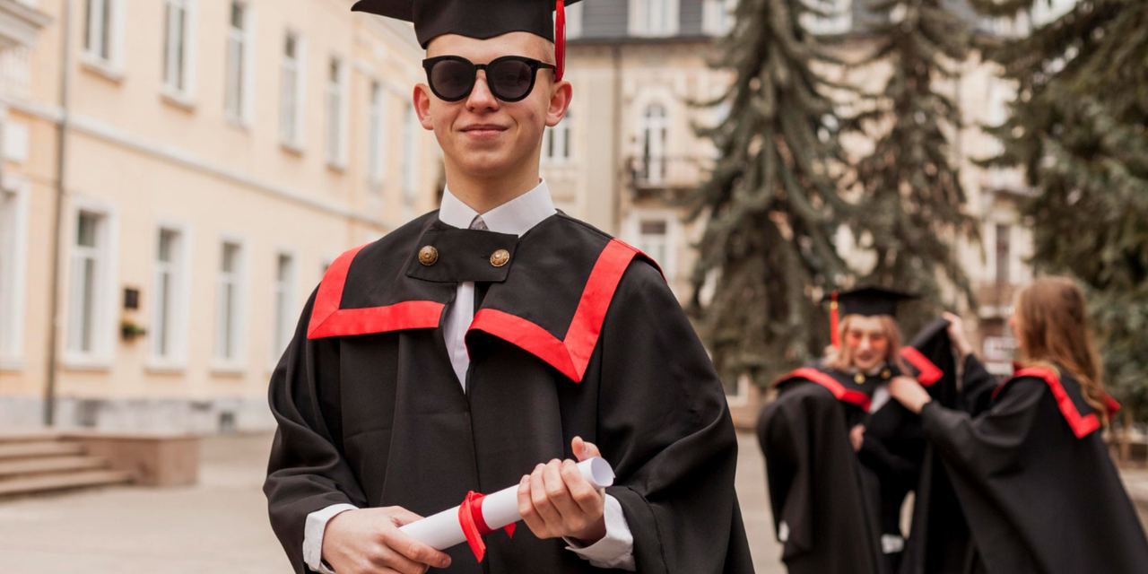 A smiling graduate wearing sunglasses and holding a diploma in front of a university building | Source: Magnific