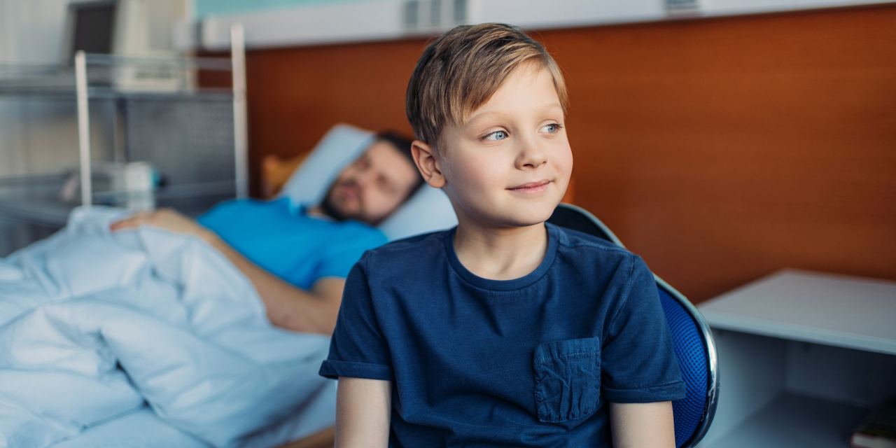 A hopeful-looking boy sitting in a hospital room | Source: Shutterstock