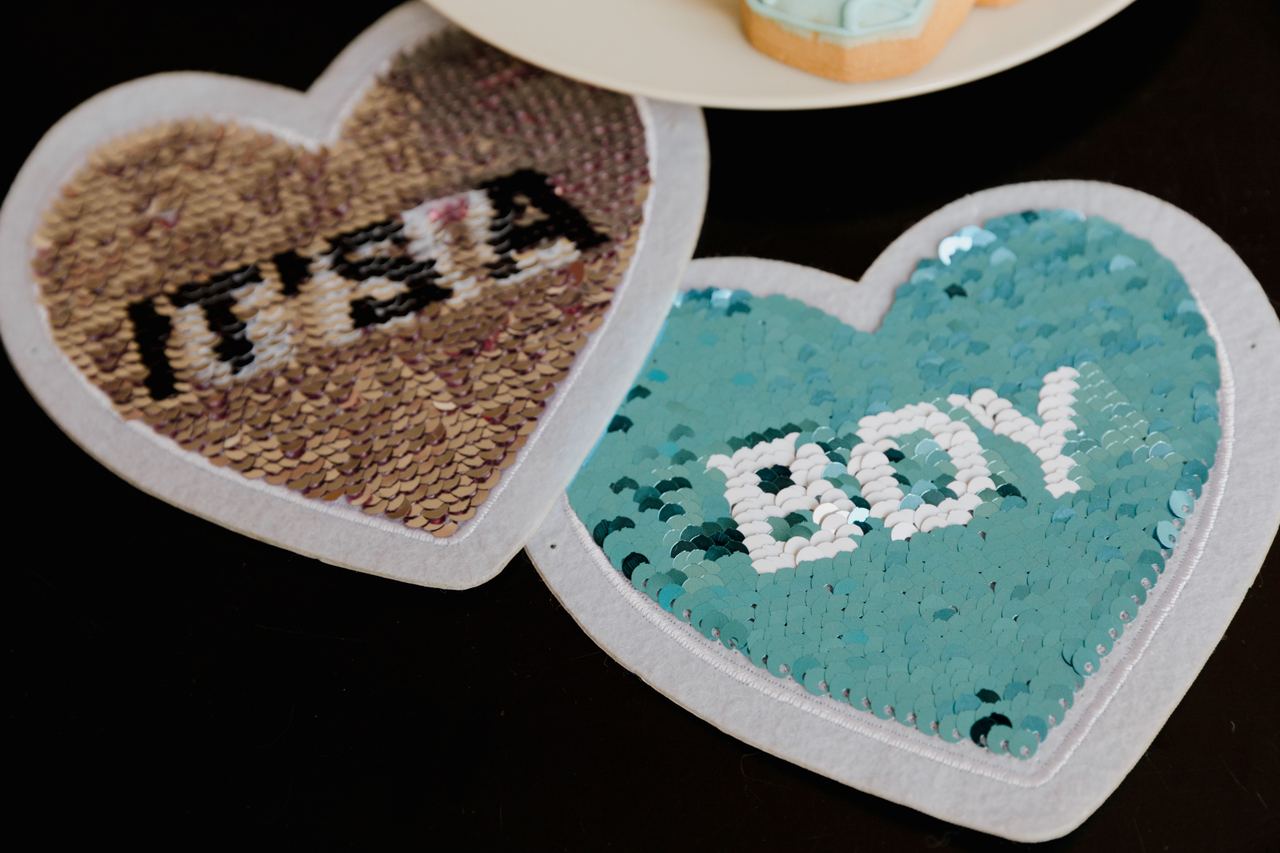 Heart-shaped sequin decorations reveal the words “It’s a Boy!” | Source: Pexels