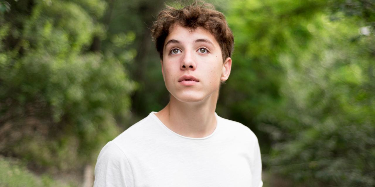A close-up of a distressed young man in the woods | Source: Magnific