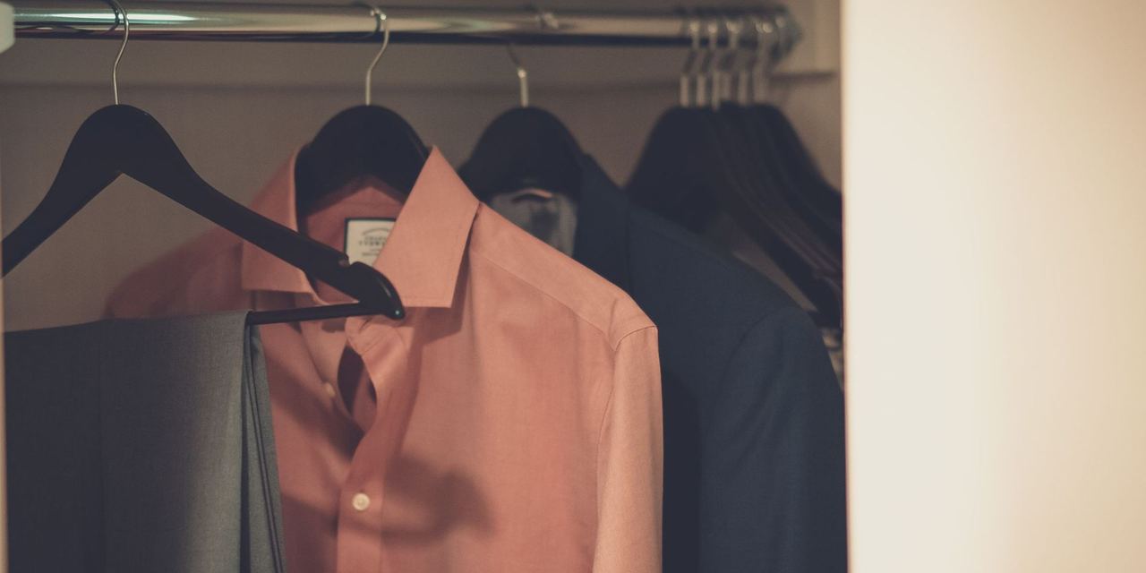 Dress shirts and formal clothing hanging neatly in a closet wardrobe | Source: Pexels