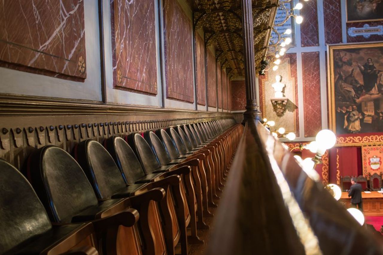 View of an ornate historic auditorium with wooden seats and rich decor, capturing a classic ambiance.
