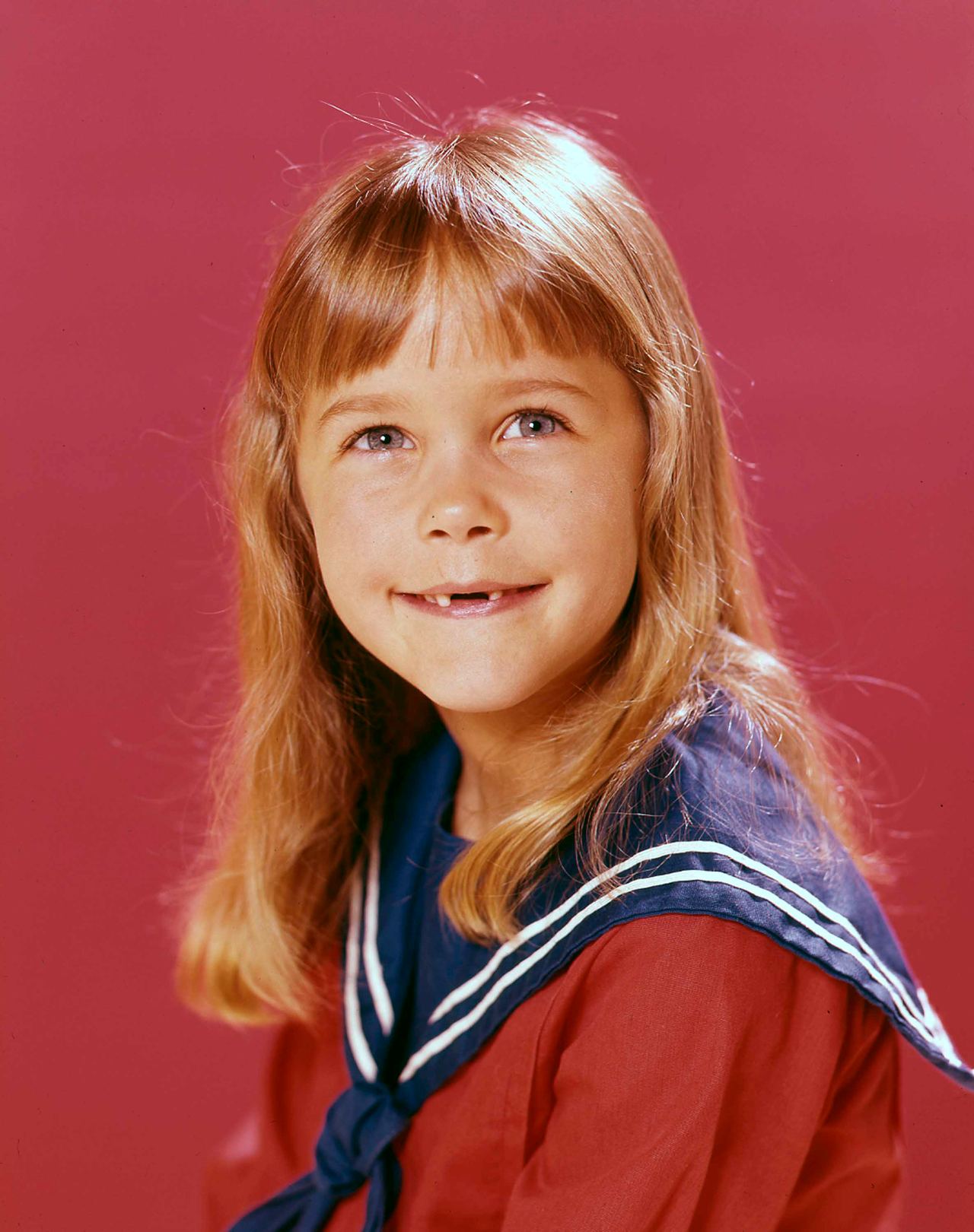 Murphy appears on her own in this childhood studio portrait, wearing her hair long with straight bangs against a red backdrop. By this stage, her face had become closely associated with Tabitha Stephens, providing another clear marker in the transformation fans are now tracing through her later photos.