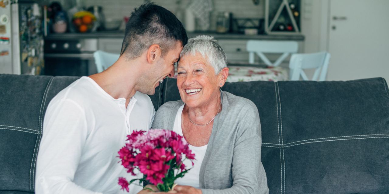 A young man giving flowers to an older woman | Source: Getty Images