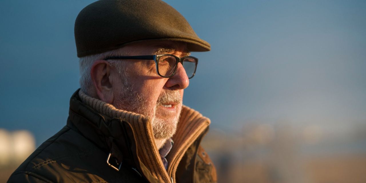 An older man gazing into the distance, his expression calm yet carrying an unspoken pain | Source: Freepik