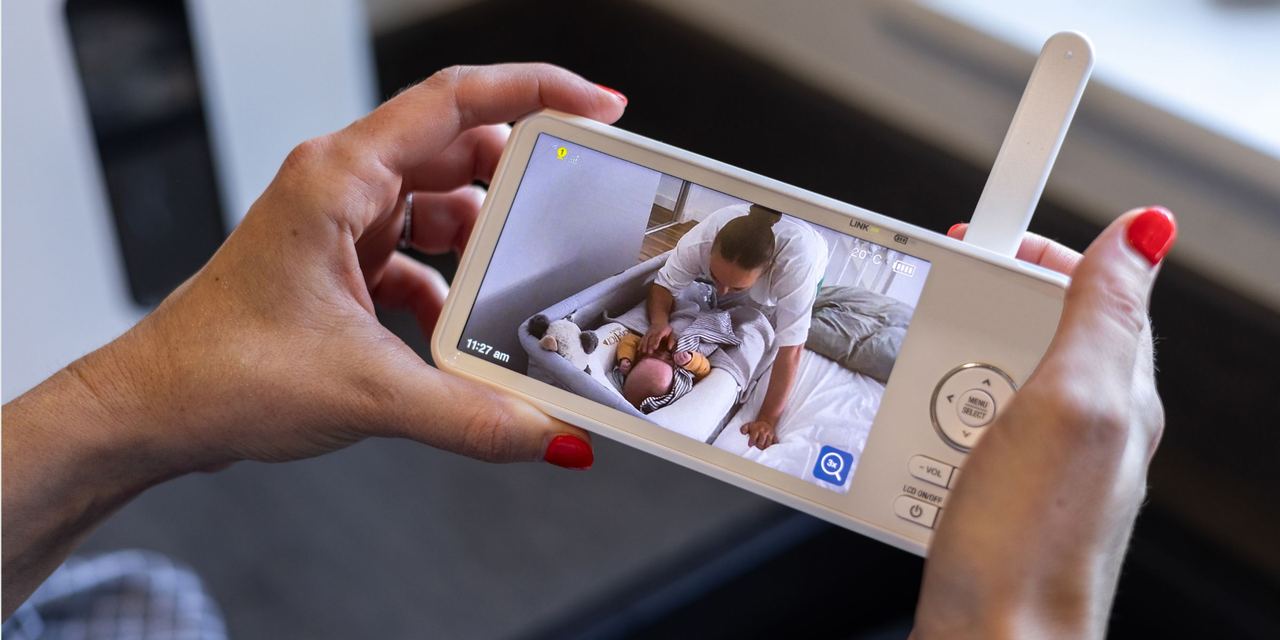 Close-up shot of a woman holding a baby monitor | Source: Getty Images