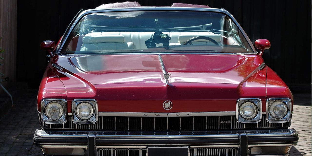 A classic red vintage convertible parked outdoors | Source: AmoMedia