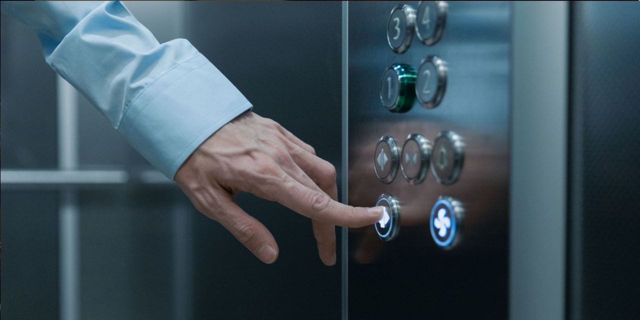 A person pressing an elevator button in a modern building | Source: Pexels