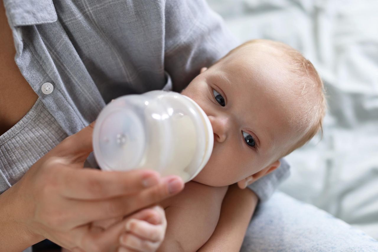 Mother feeding an infant | Source: Shutterstock