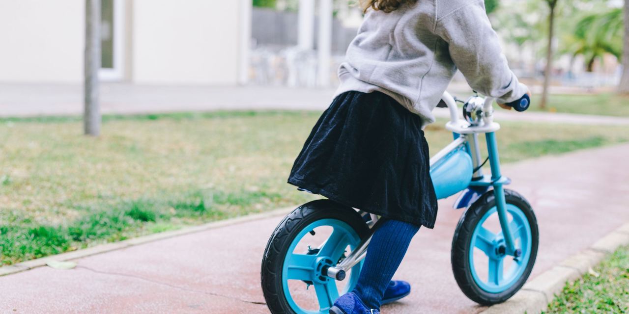 A little girl riding a bike | Source: Freepik