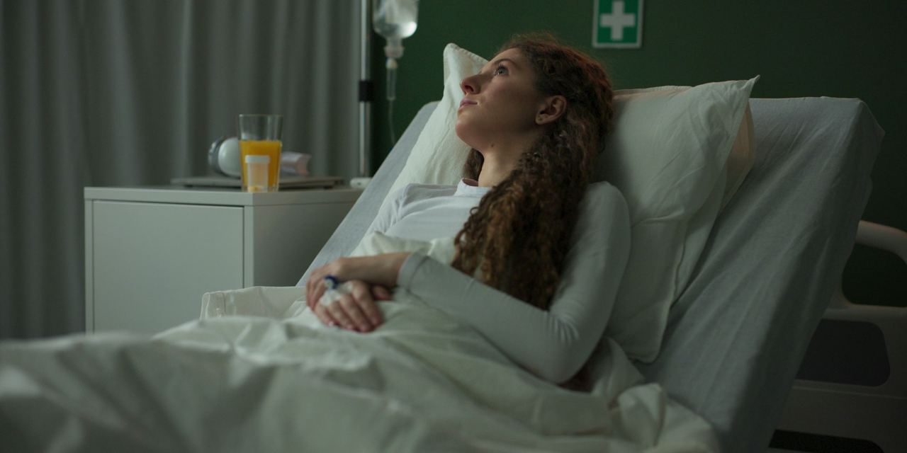 Hospitalized woman resting in bed | Source: Shutterstock