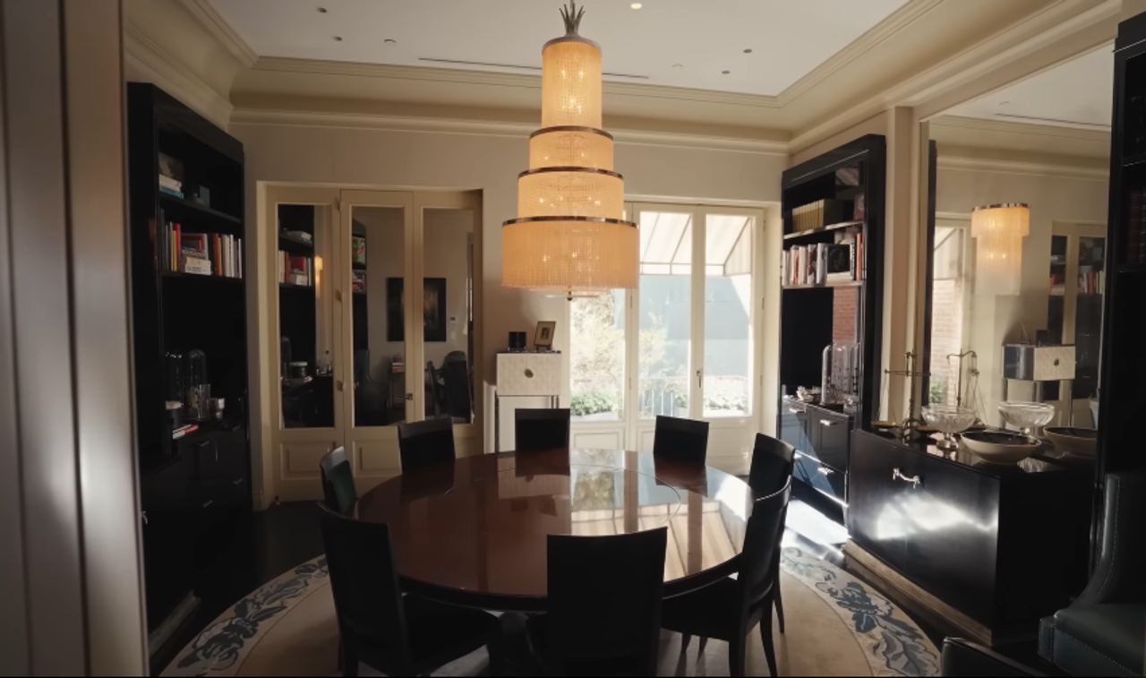 The dining room reflects the couple's love of Deco drama without losing the feeling of a real family home. Many of the home's crystal chandeliers, decorative objects, and Art Deco pieces were found during a Paris shopping trip with Sofield. | Source: YouTube/Architectural Digest