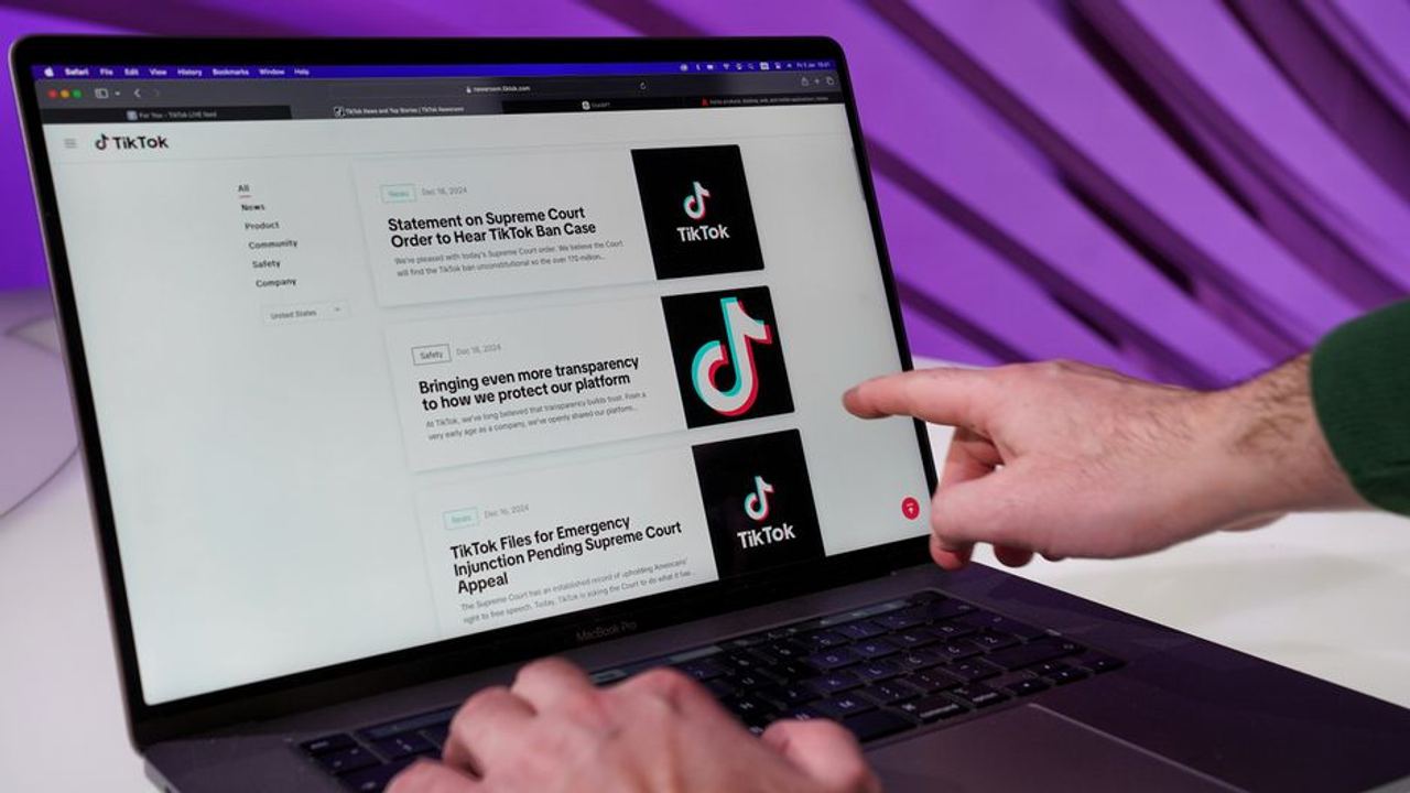 Close-up of a person interacting with TikTok content on a laptop indoors.