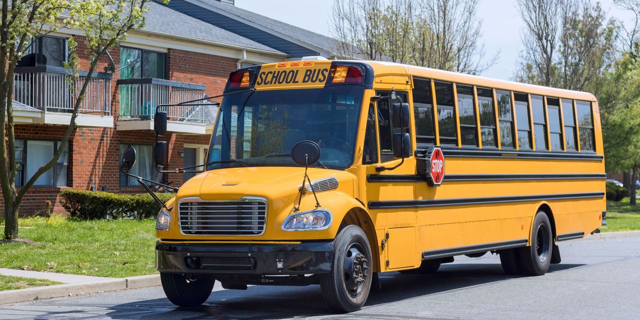 A yellow school bus on the street | Source: Shutterstock
