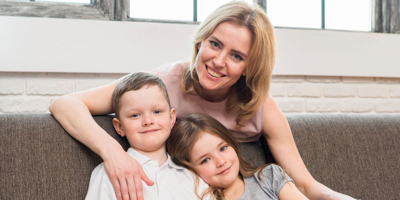 A happy mother with her two children | Source: Magnific
