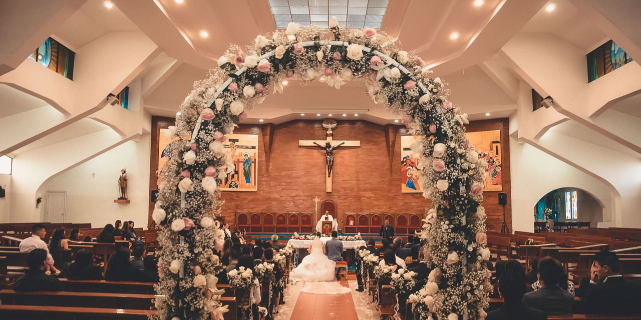 Wedding ceremony inside a flower-decorated church | Source: Pexels