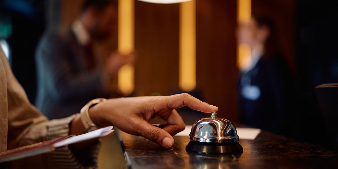 A person ringing a bell at a hotel reception | Source: Shutterstock