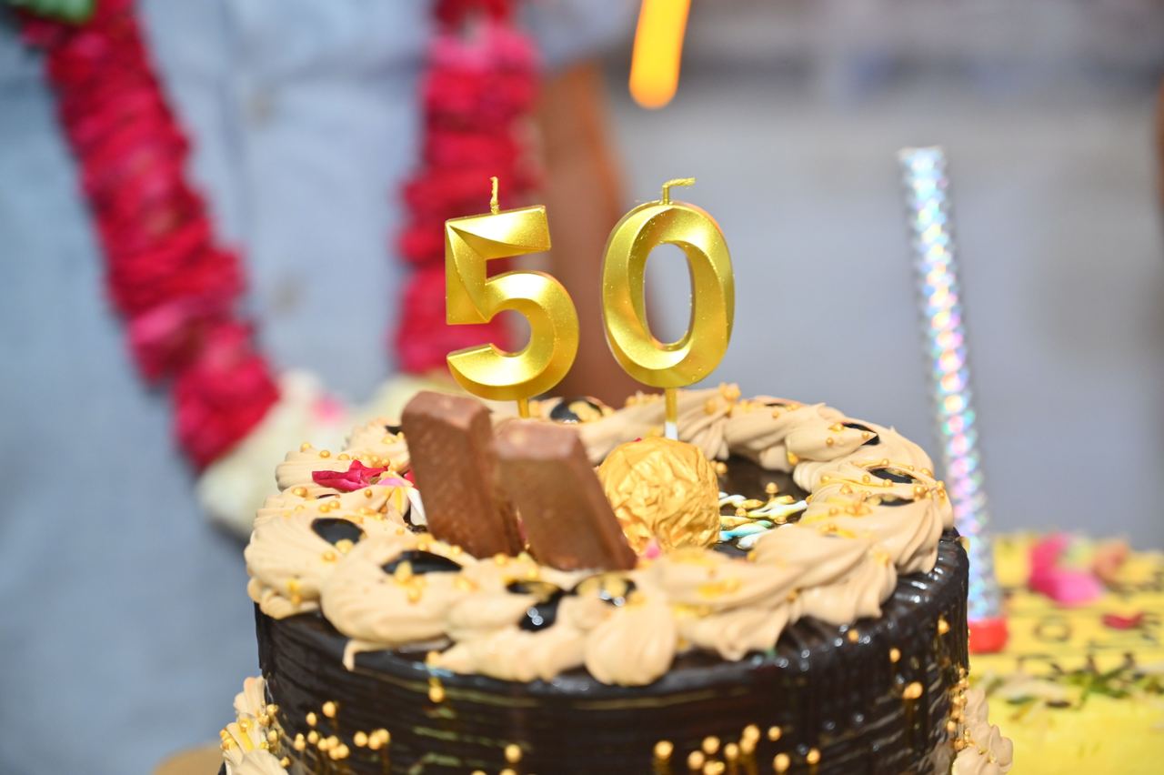 Elegant chocolate cake with golden 50th anniversary candles | Source: Pexels