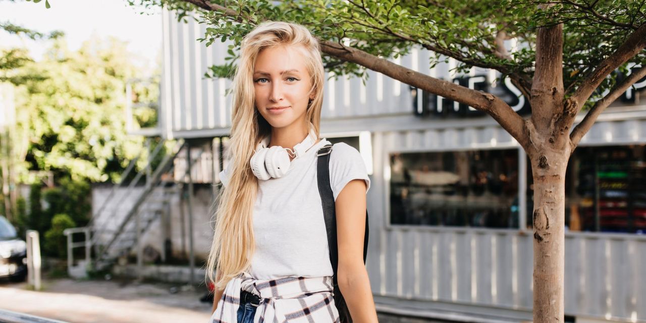 A teen girl standing on a sidewalk | Source: Freepik
