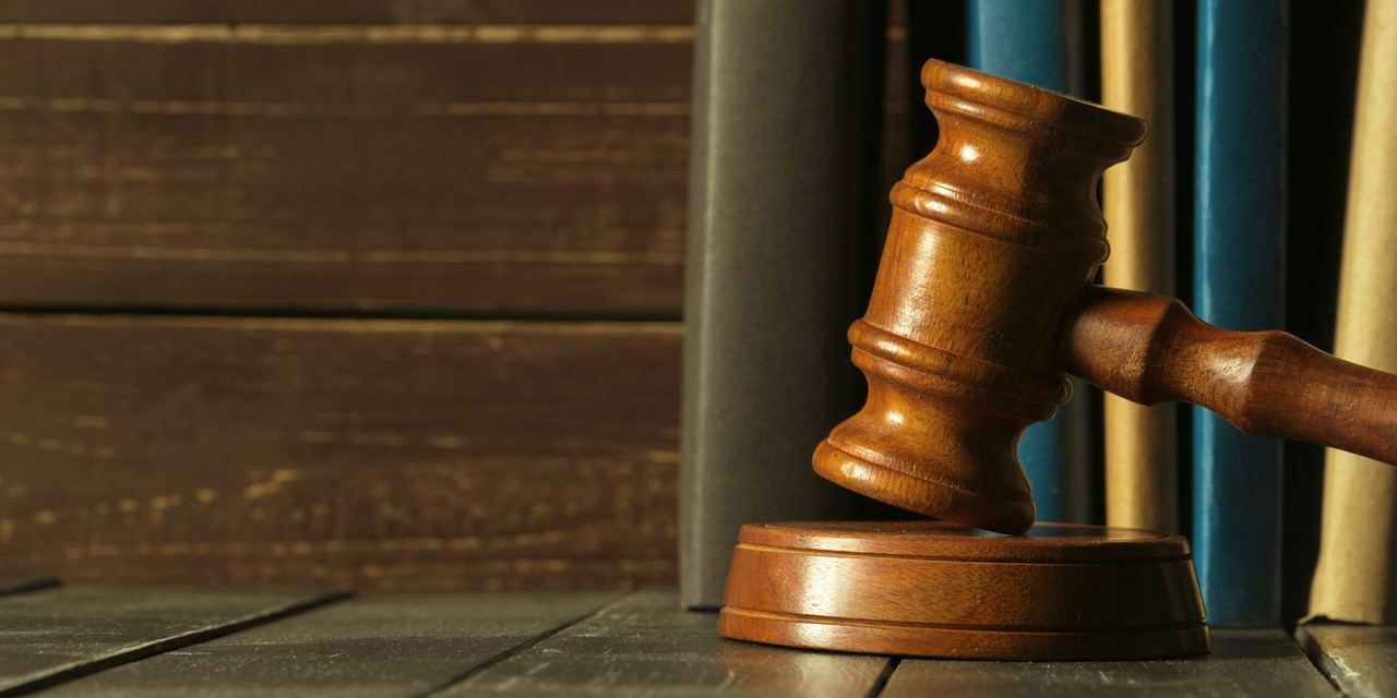 A gavel being struck in a courtroom | Source: Freepik