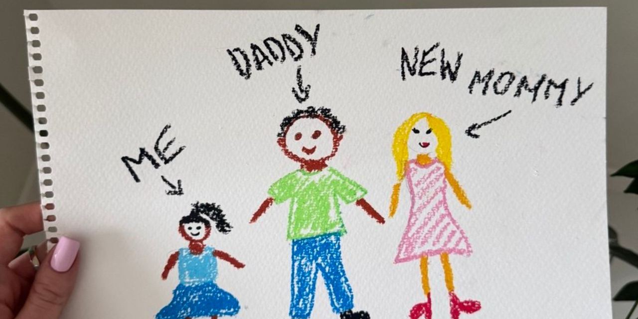 A woman holding a child's hand-drawn family portrait | Source: AmoMedia