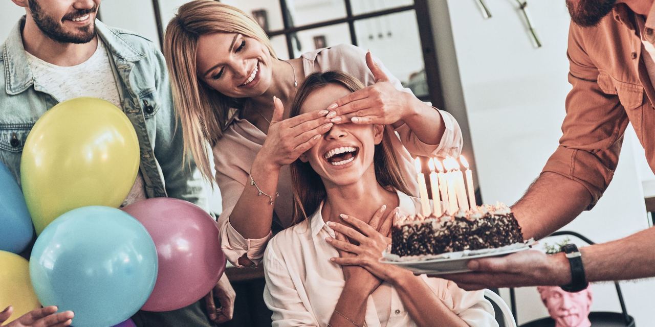 Group of people celebrating a surprise birthday party | Source: Shutterstock