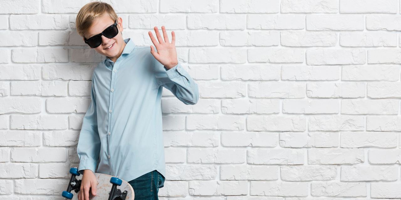 A boy with a skateboard and sunglasses | Source: Magnific