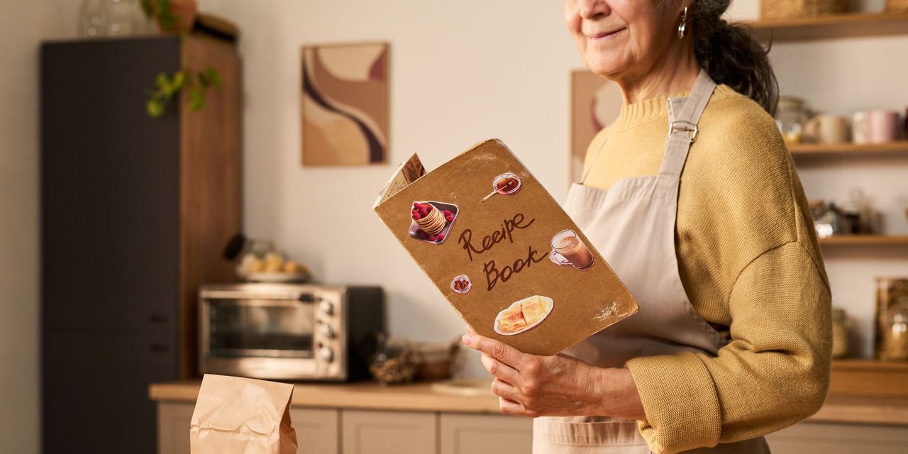 A woman holding a recipe book | Source: Shutterstock
