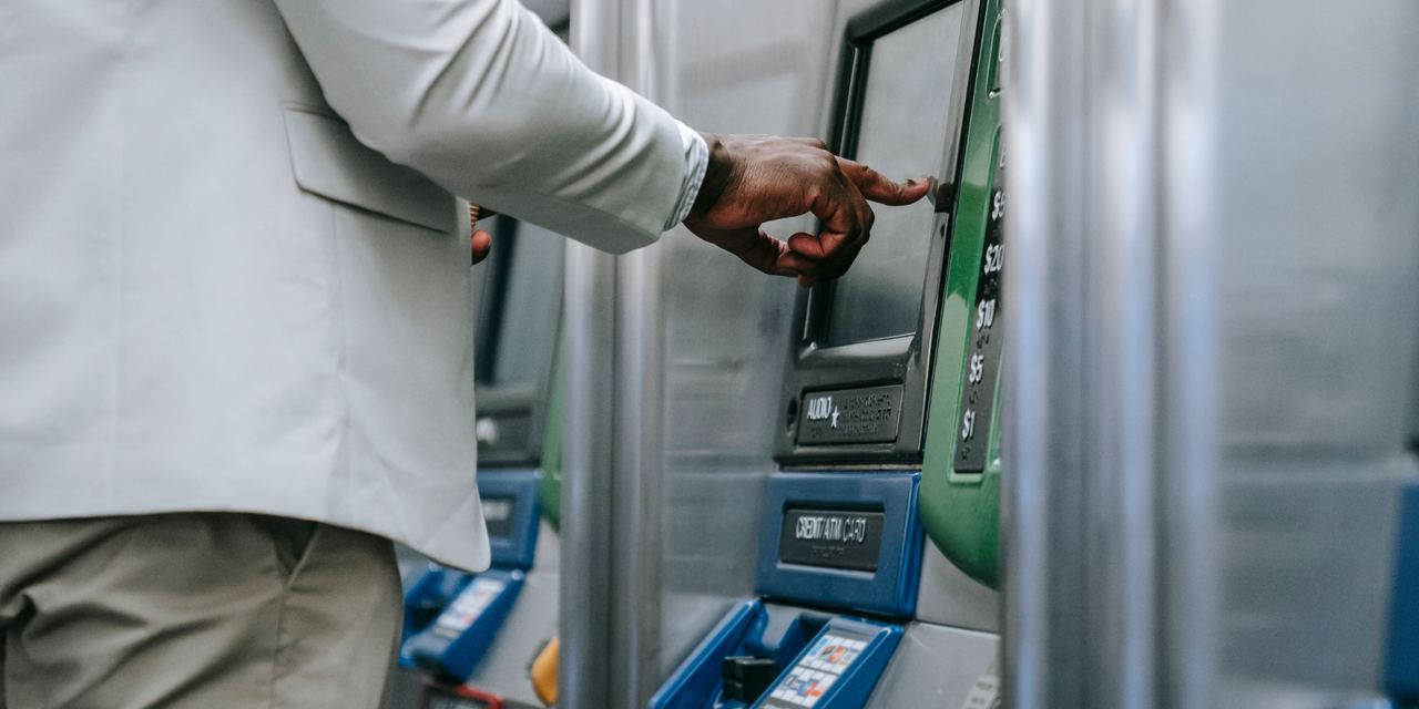 A man withdrawing money at an ATM | Source: Pexels