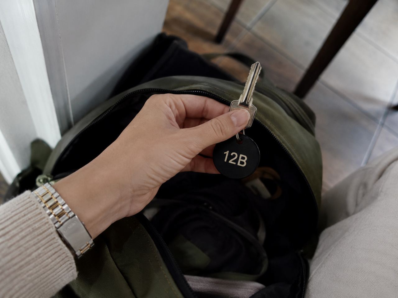 A person holding a key labeled "12B" | Source: Amomedia
