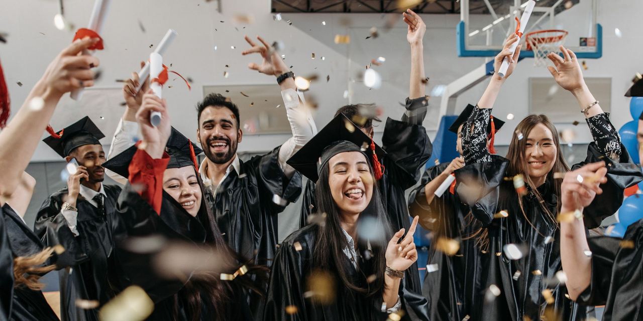 Happy college graduates celebrating | Source: Pexels