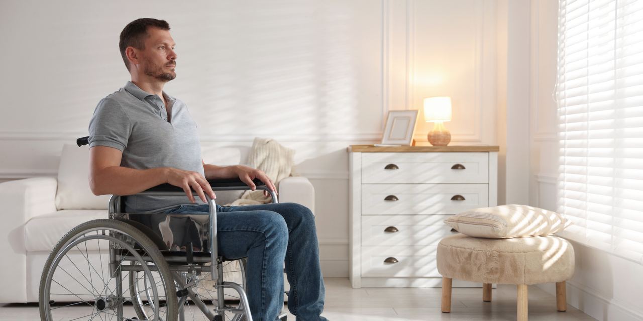 A man in a wheelchair | Source: Shutterstock