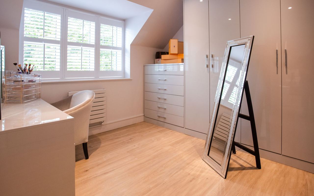 Bright dressing room with fitted wardrobes and a full-length mirror | Source: Pexels