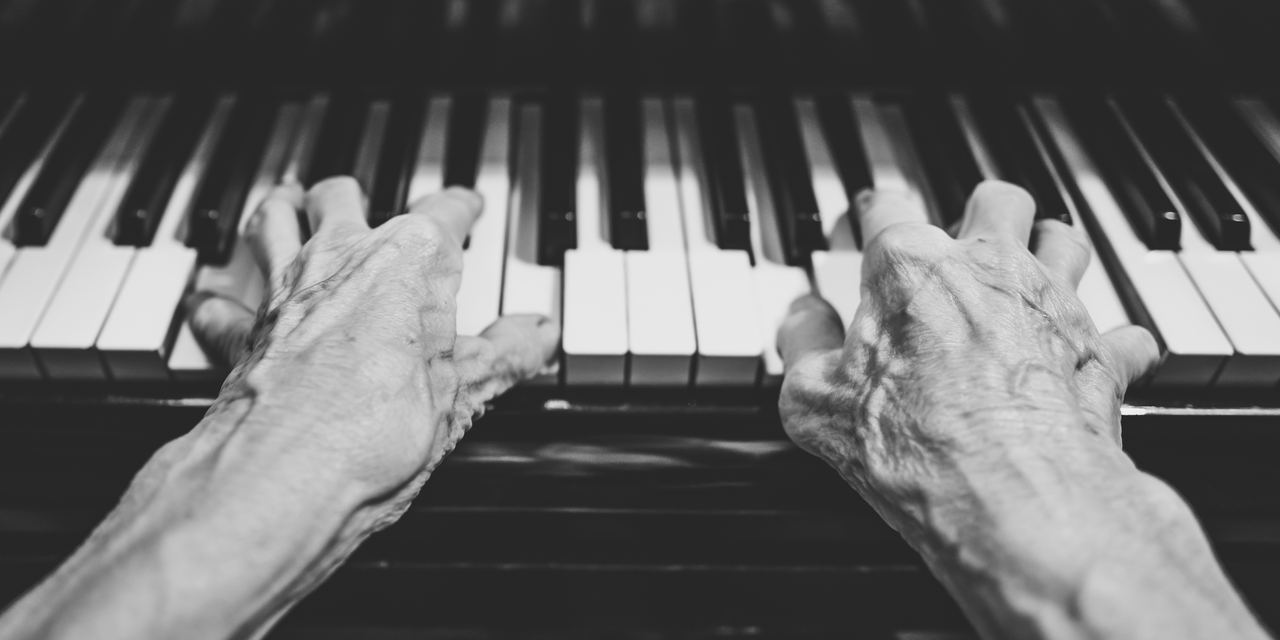 An elderly woman playing the piano | Source: Shutterstock