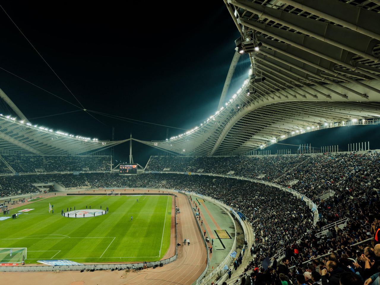 A crowded soccer stadium under bright lights | Source: Pexels