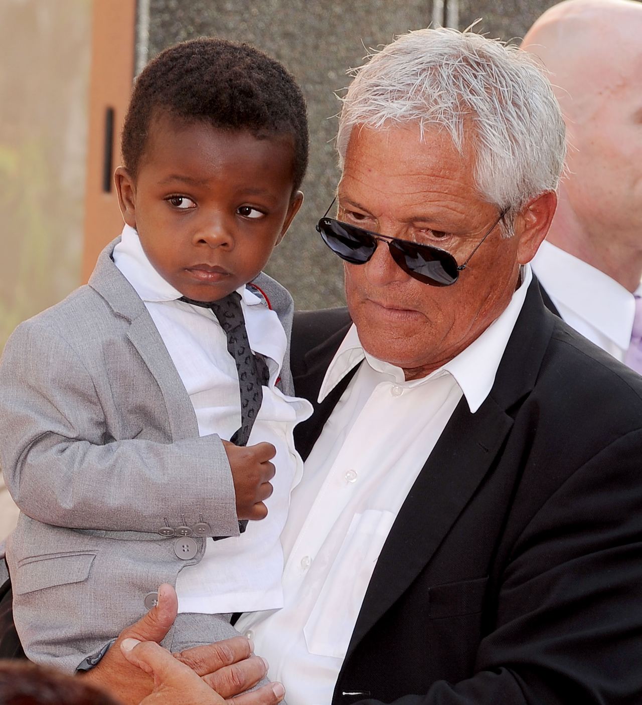 Louis Bardo as a little boy being carried by someone at his mom's Hand and Footprint Ceremony in Hollywood, California on September 25, 2013. | Source: Getty Images