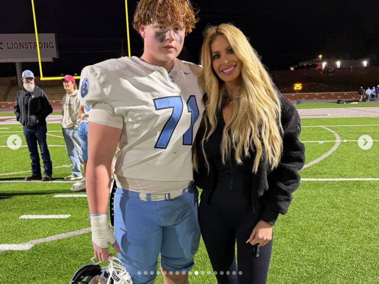 KJ Biermann poses with his mother, Kim Zolciak, on a football field in a photo that reflects her pride in his athletic pursuits. Kim praised his “work ethic, dedication, discipline, and drive” in a birthday tribute shared weeks after the alleged April incident and months before his August arrest. | Source: Instagram/kimzolciakbiermann