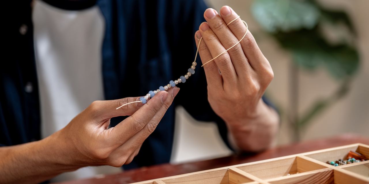 A person holding a beaded bracelet | Source: Shutterstock