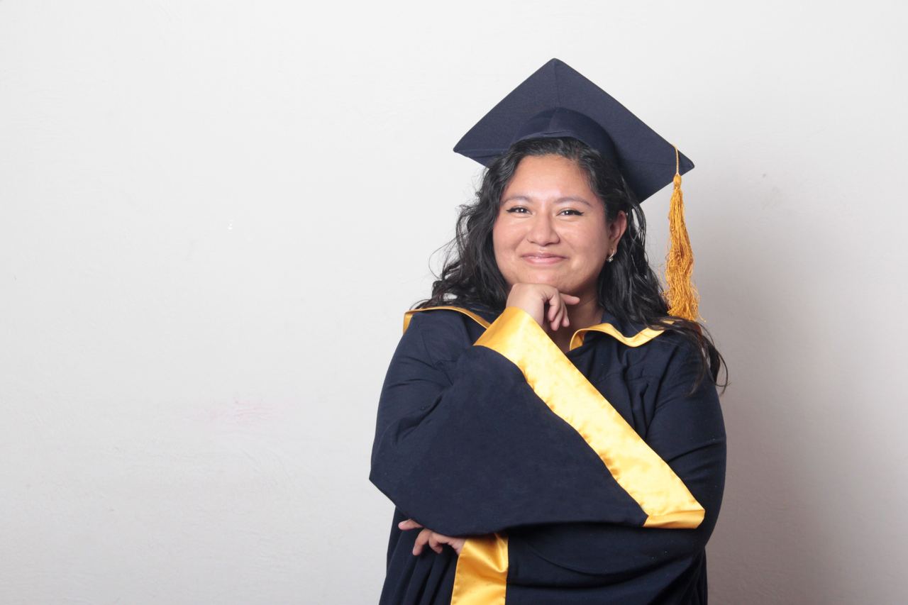 A girl in a graduation cap and gown | Source: Shutterstock