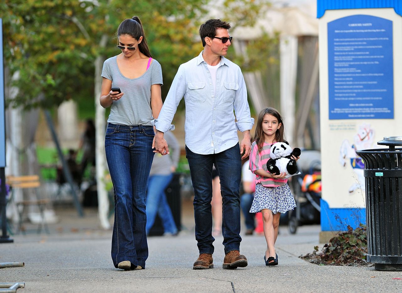 Suri Cruise is pictured with her parents, Tom Cruise and Katie Holmes, in 2011. Years later, she drew attention after appearing publicly as Suri Noelle instead of using the Cruise surname. | Source: Getty Images