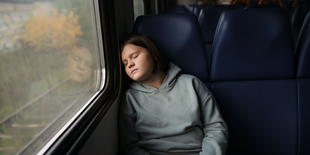 A teenage girl asleep on the train | Source: Getty Images