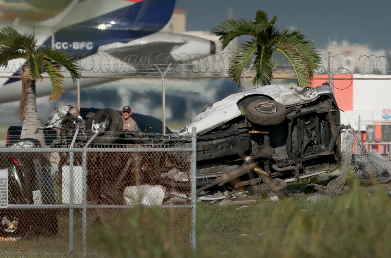 Damaged vehicles show the impact of the cargo plane's path after it continued beyond the runway. Officials confirmed five deaths after the aircraft struck multiple vehicles during the crash. | Source: Getty Images