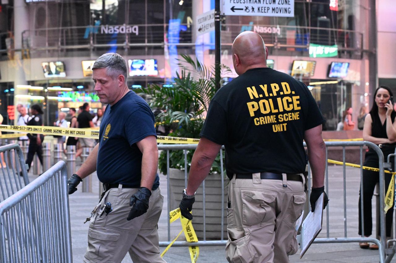 NYPD crime scene investigators worked behind police tape after the violence near Seventh Avenue in Times Square. The police response later drew questions from Cisernos' family, including her mother's pointed question about why officers did not grab her by the arm. | Source: Getty Images
