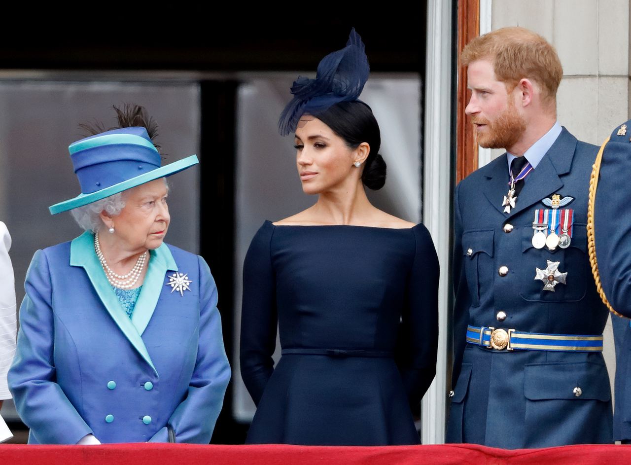 Queen Elizabeth II watches Meghan and Prince Harry during the RAF centenary flypast at Buckingham Palace in July 2018. | Source: Getty Images