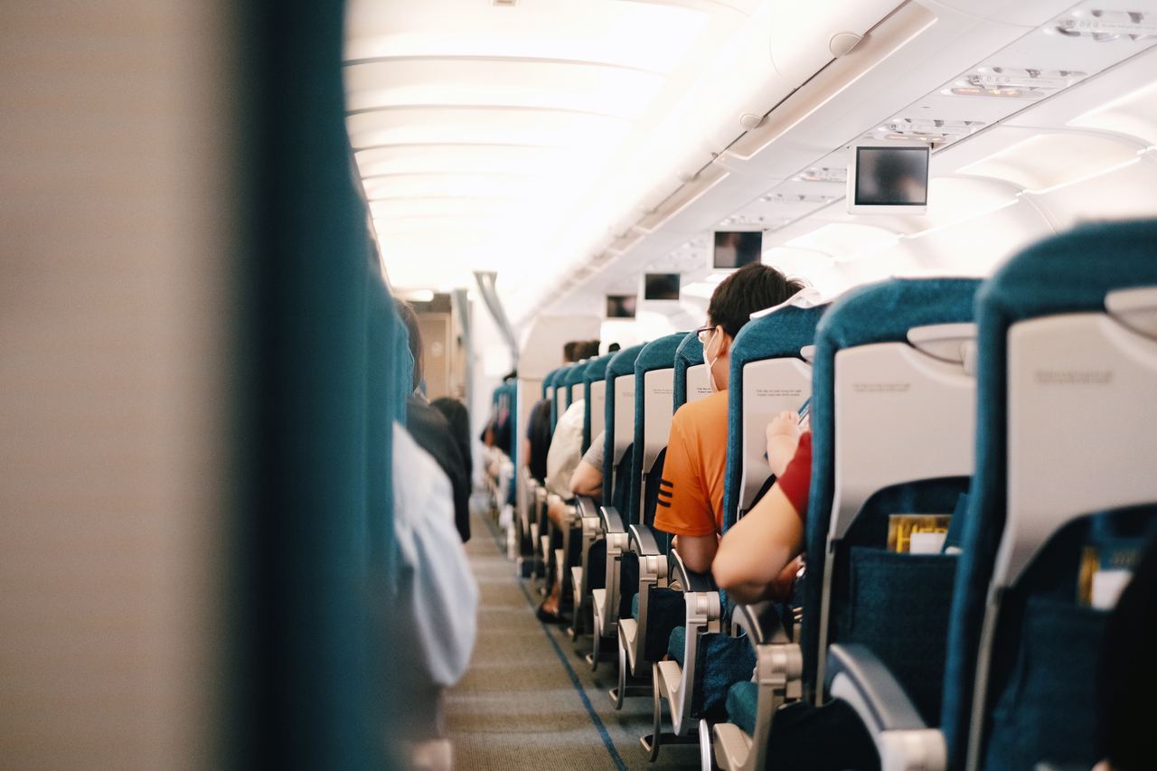 Interior view of airplane cabin showing passengers seated during a flight | Source: Pexels