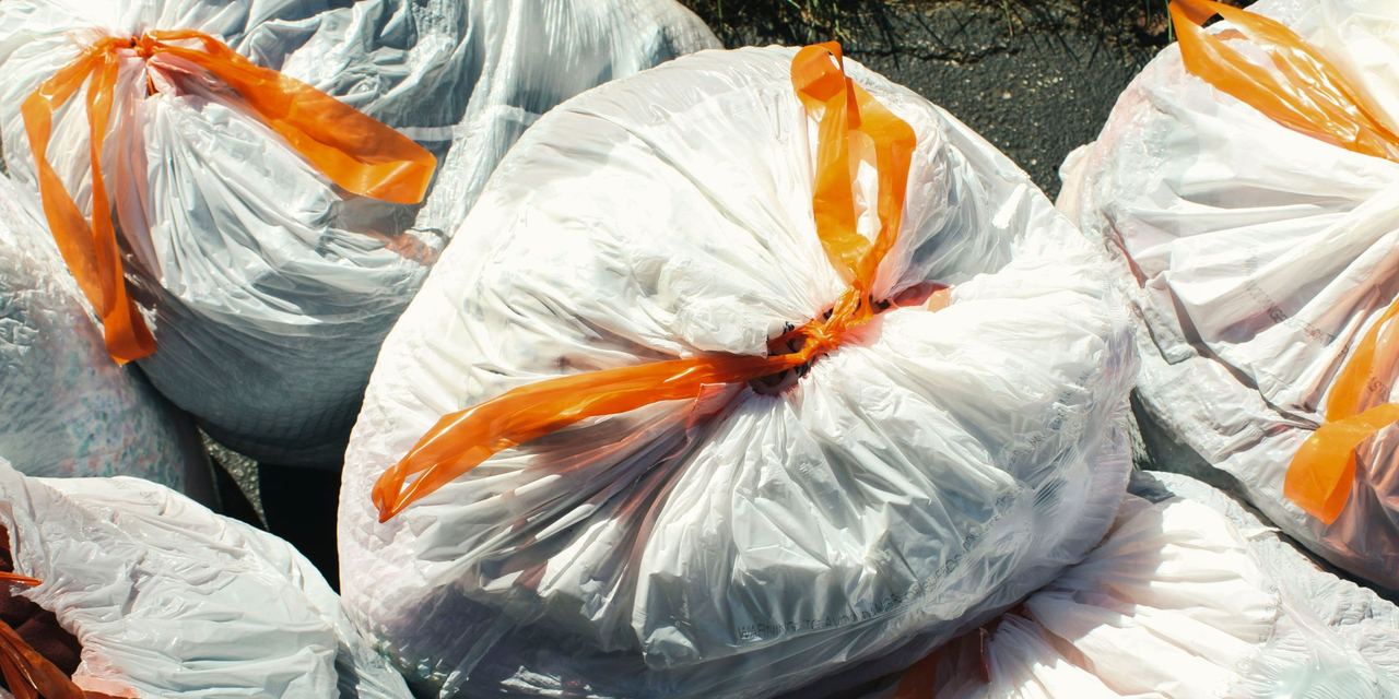 An aerial view of white trash bags filled with trash | Source: Pexels