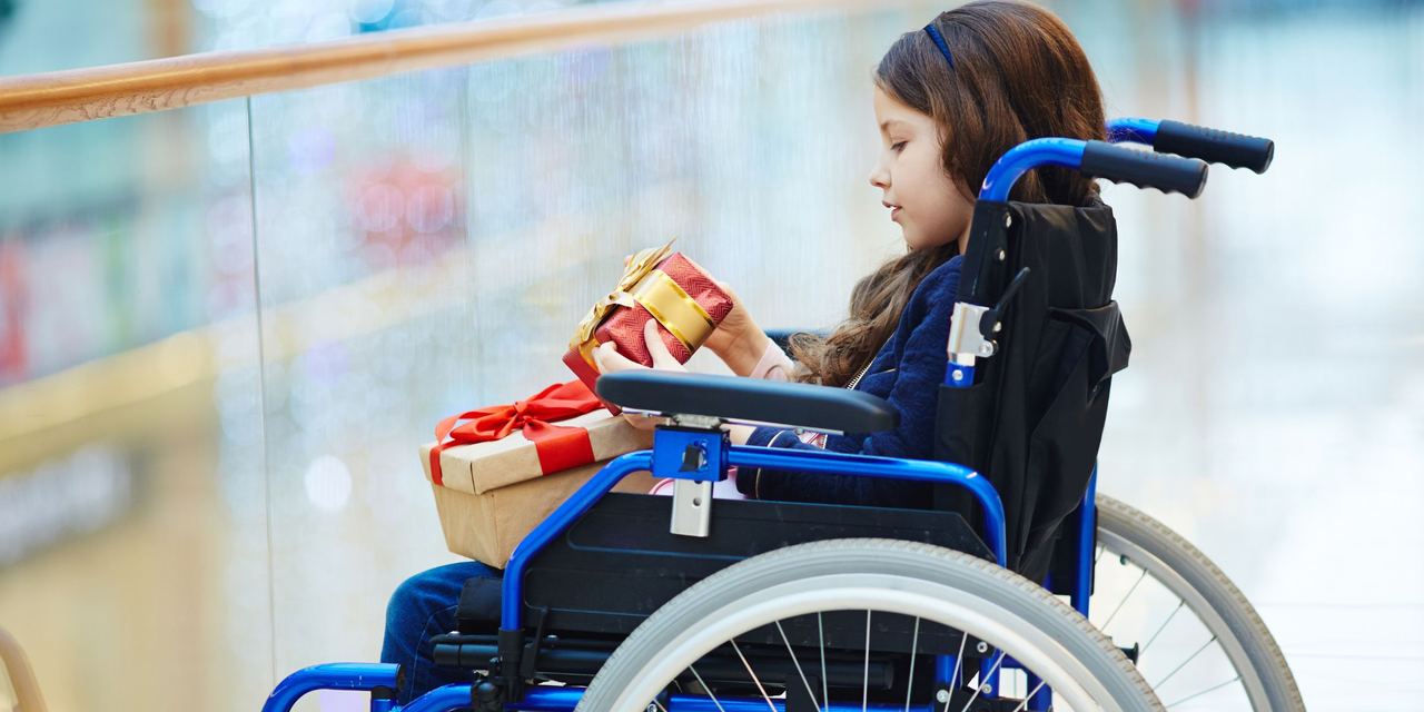 A little girl in a wheelchair | Source: Freepik