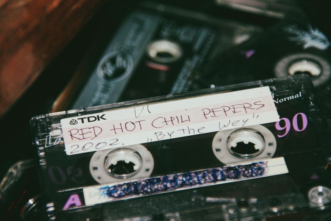 From above of vintage audio cassette with handwritten inscription placed on tape recorder
